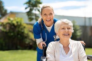 Nurse taking care of an elderly person on a wheelchair 