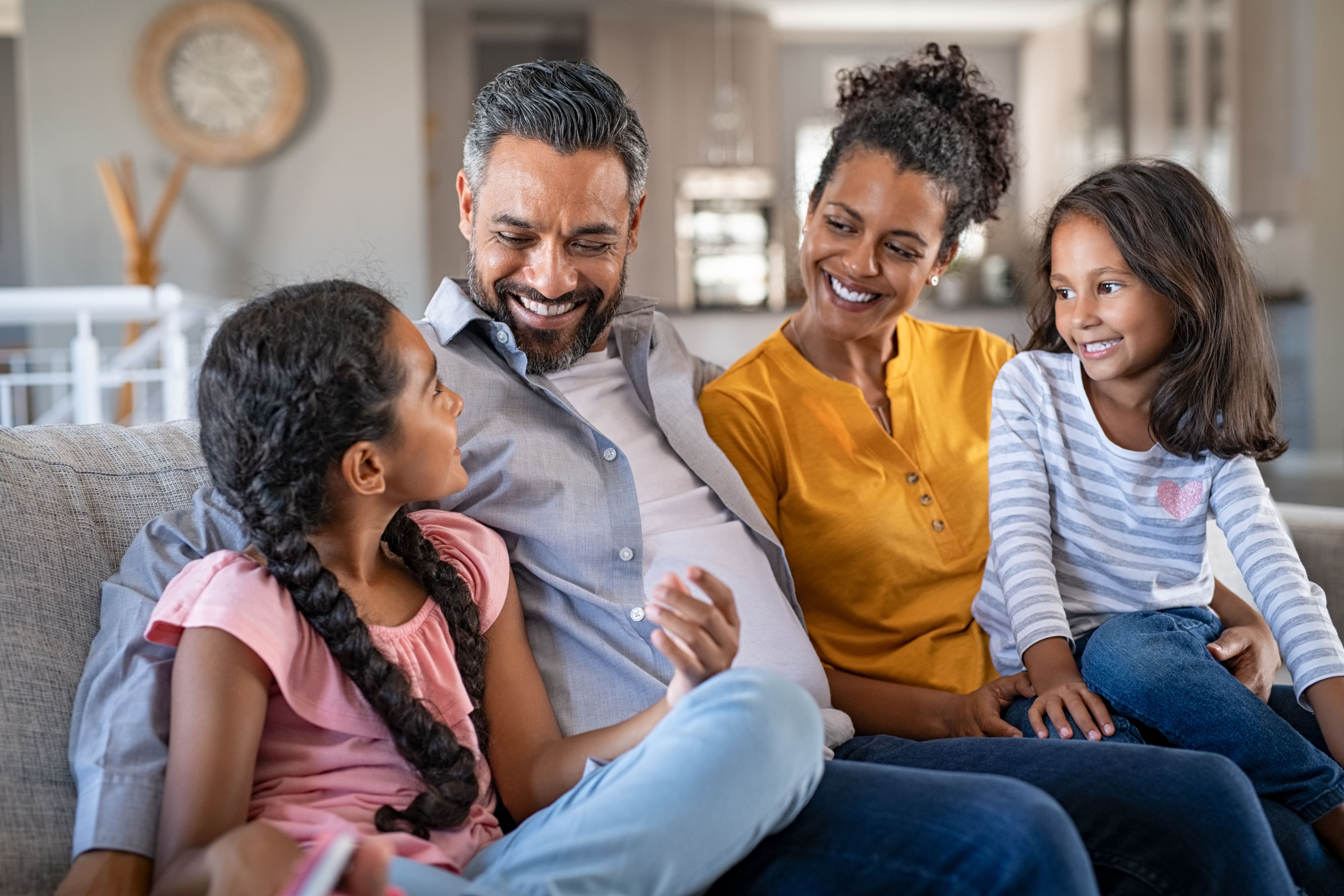 Smiling parents talking to their daughter about "Is collagen good for gut health?"